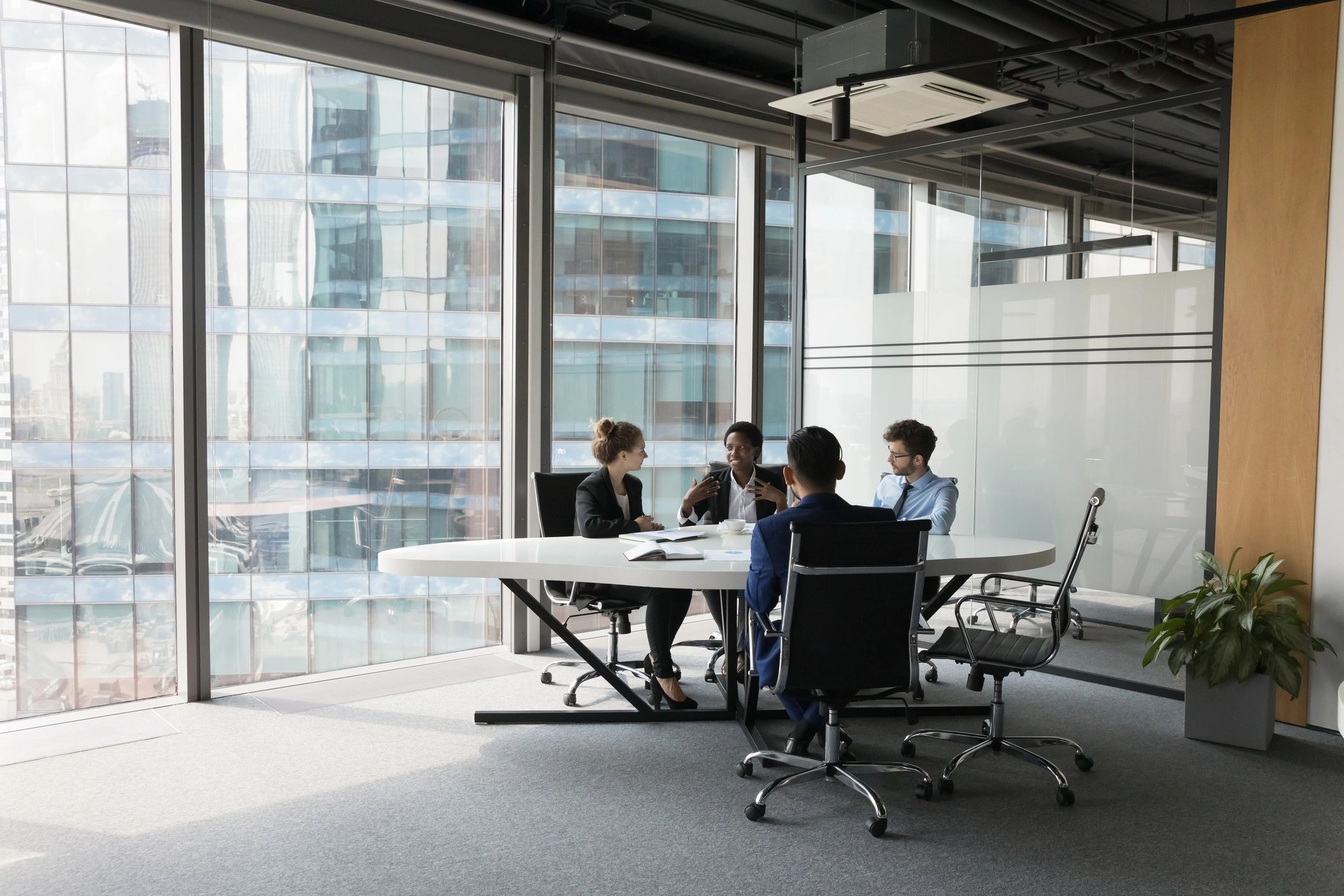 Healthcare consulting style team discussion in a meeting room