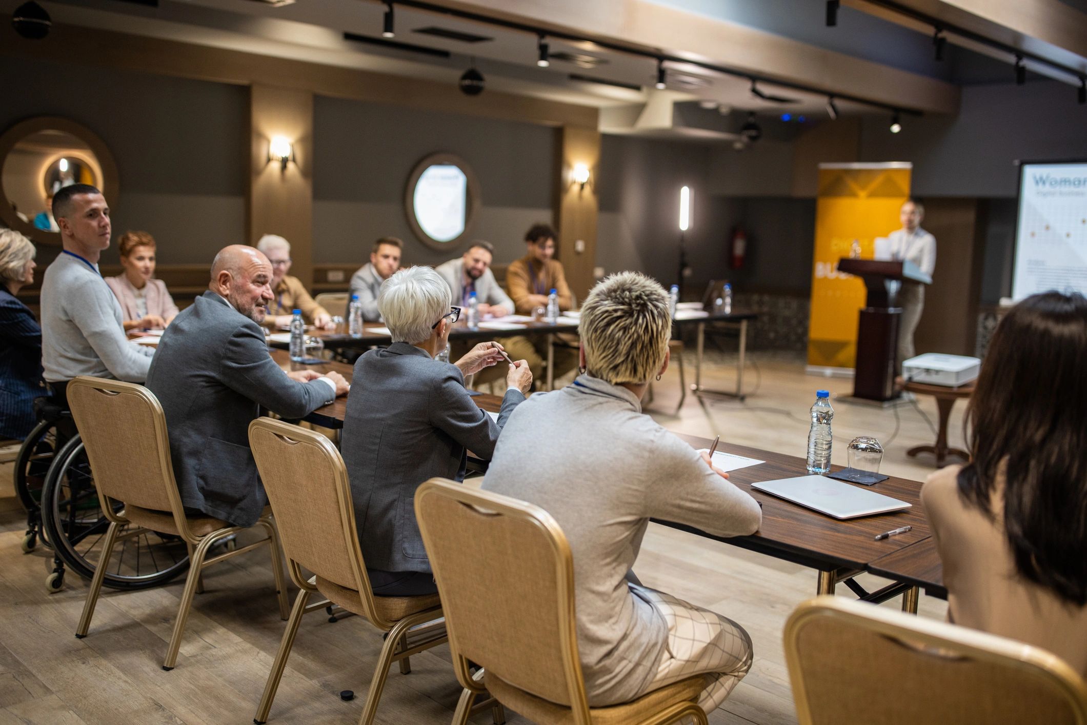 Business conference participants listening to a speech