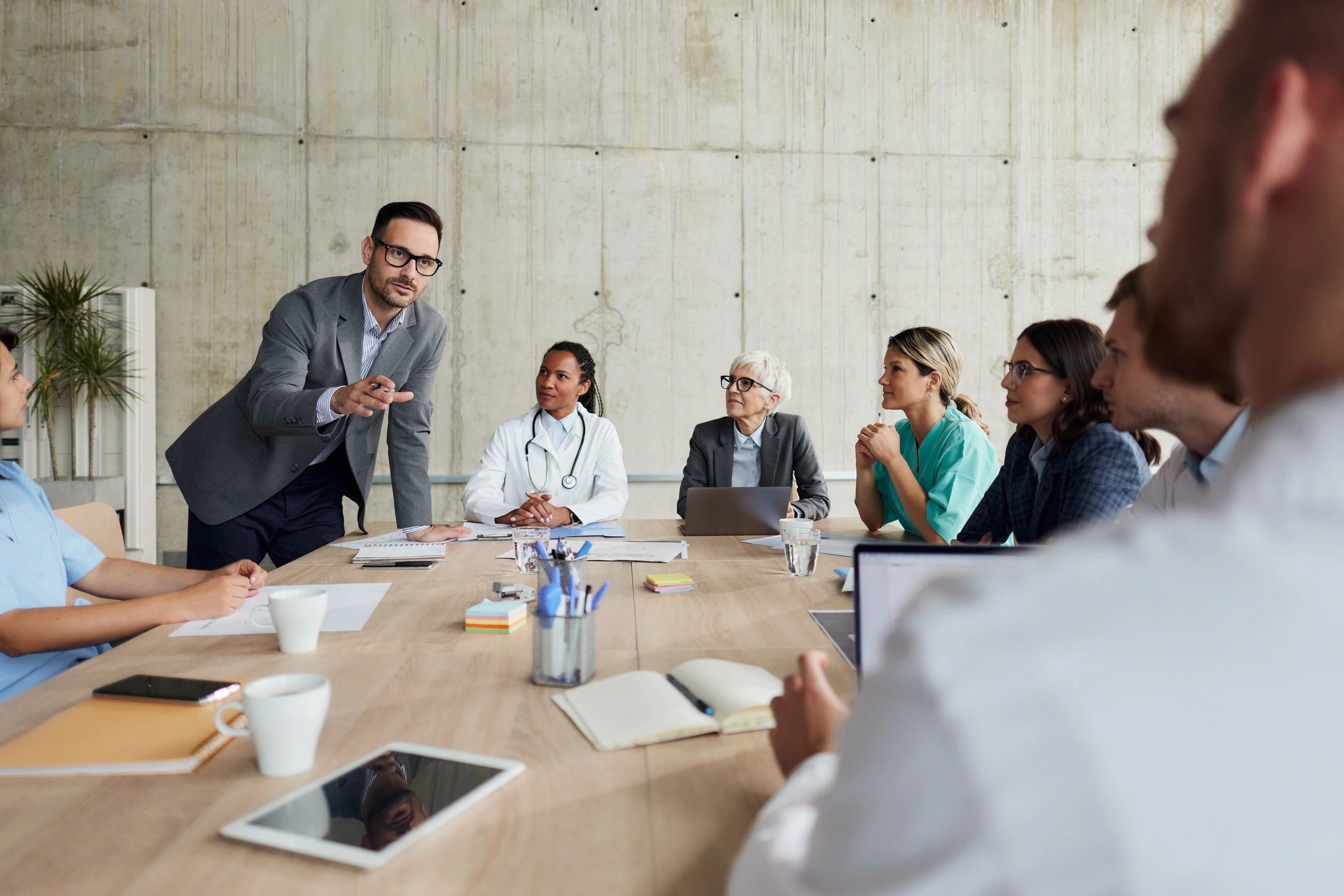Businessman leading a meeting with medical experts in hospital