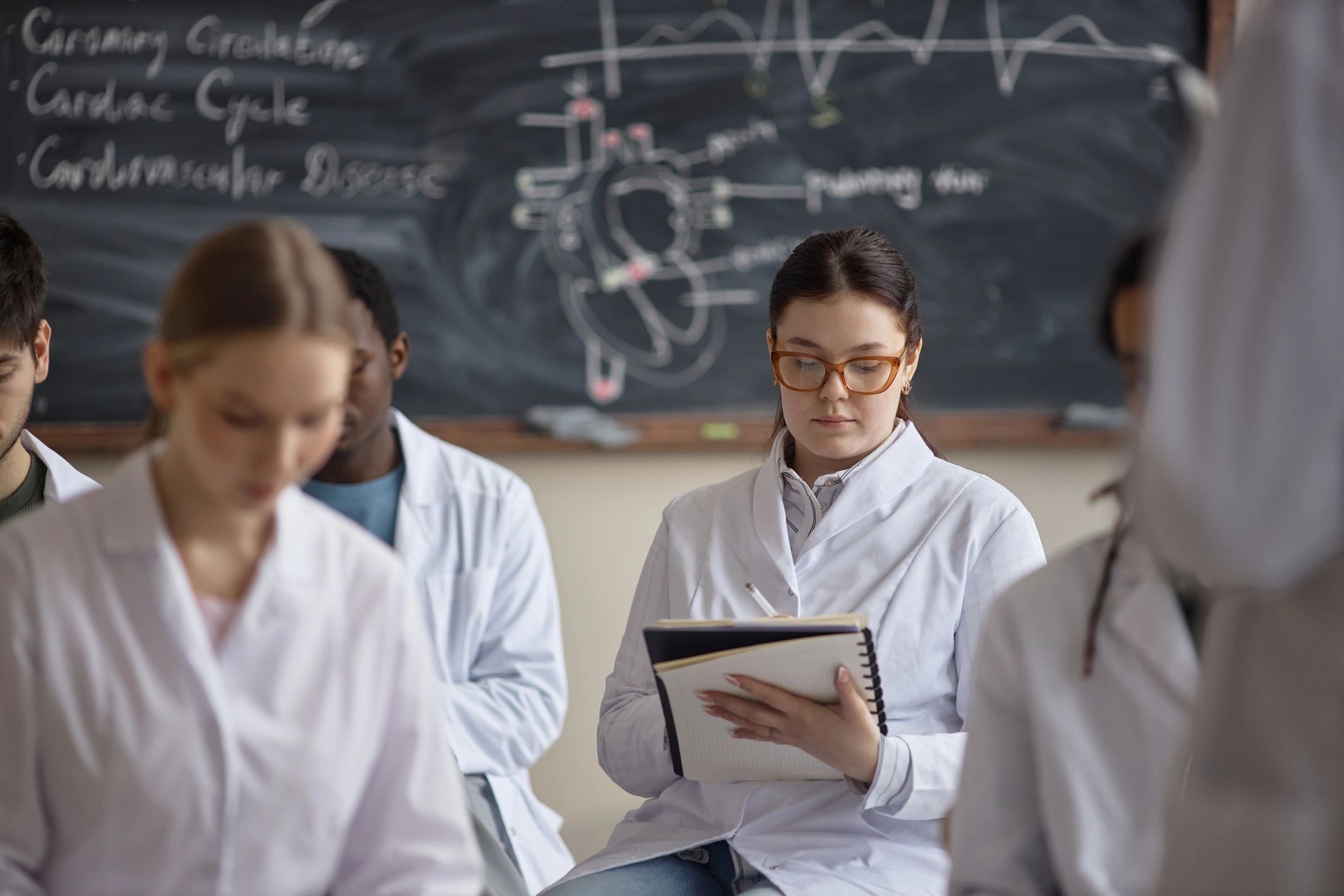 Healthcare student taking notes during a professional education course