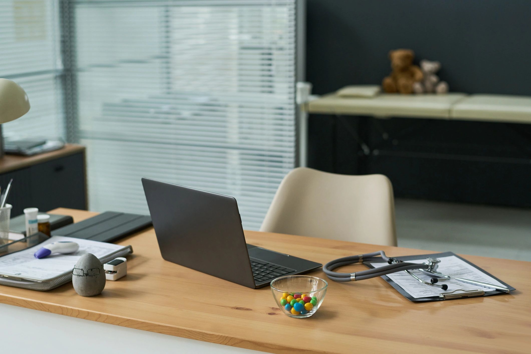 Medical office workspace with laptop and consultation materials